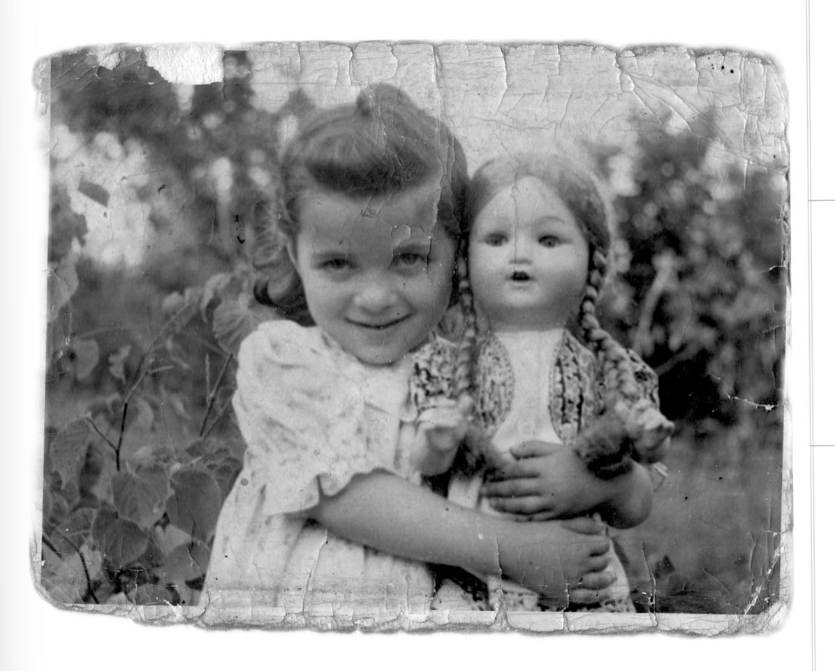 Anna as a little girl with her doll